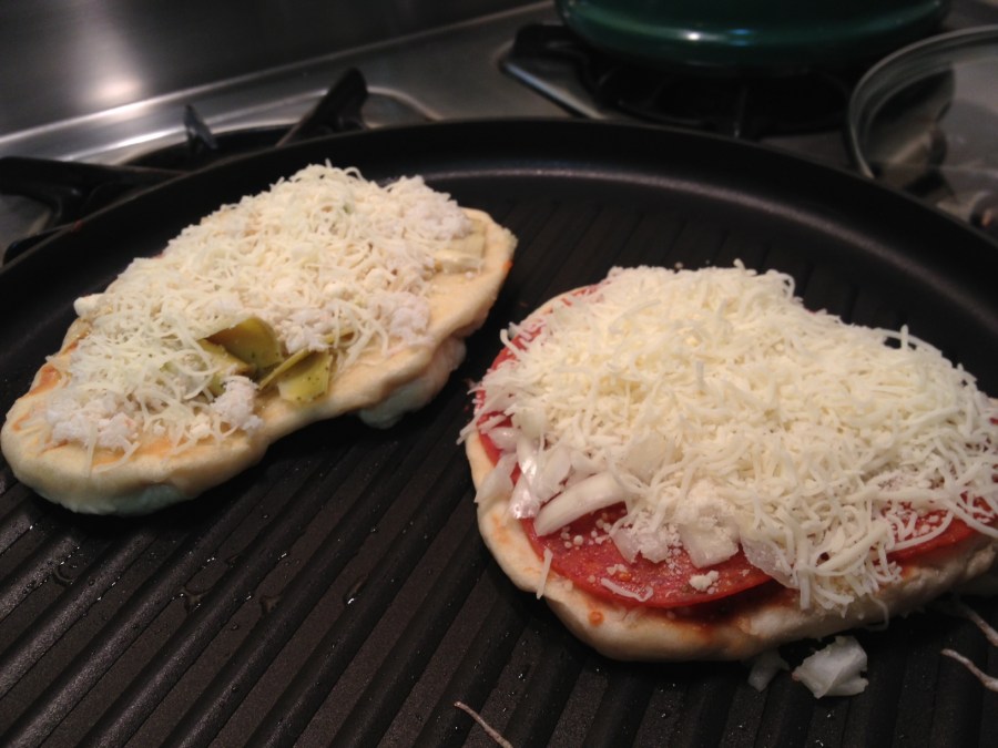 One the left: artichoke heart and crab white pizza. On the right: pepperoni and onion.