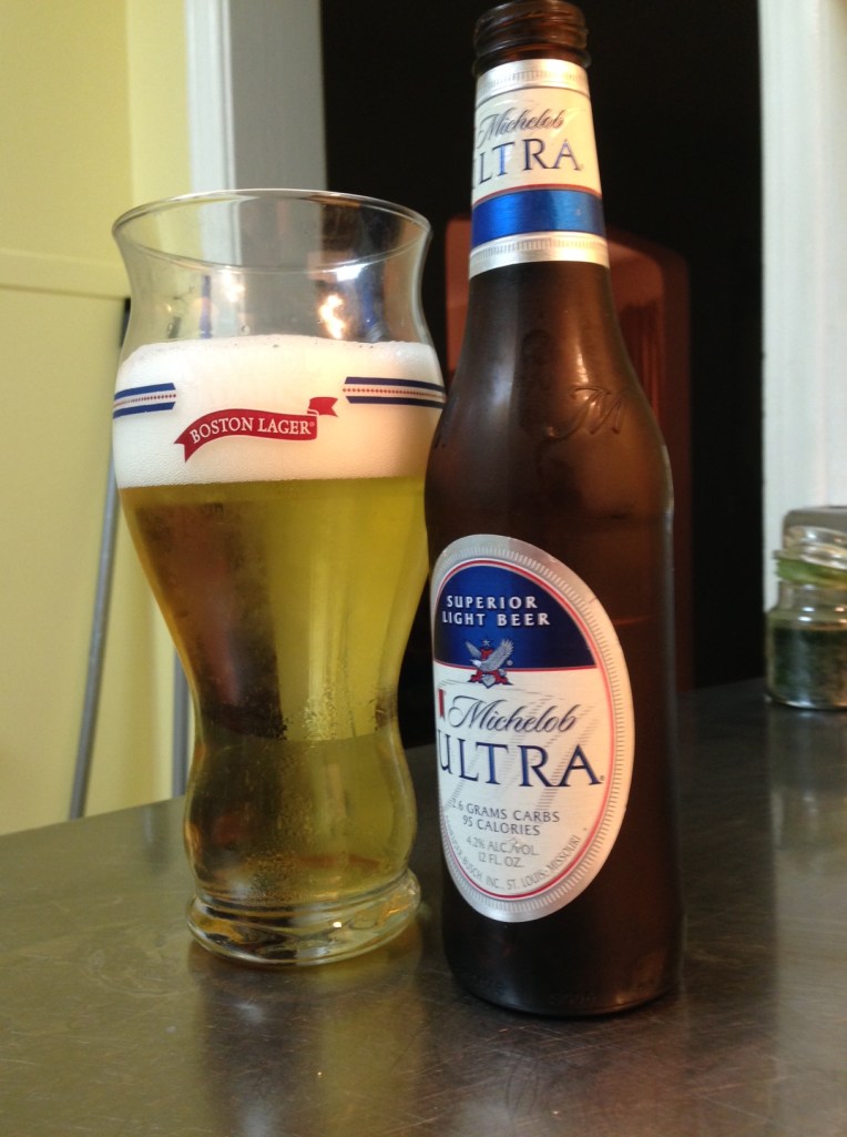 Michelob Ultra, Anheuser‑Busch InBev. 4.2 percent alcohol by volume. Of all the beers in the sixer, this is the one that actually made me angry. It is beer for people who don't actually want to drink beer. It is a fiction created by marketers. It is an affront to everything I stand for. And it also poured the biggest head of any of the beers in the six. Go figure. But that was the only surprise. Mich Ultra is watery, corny and way too sweet.